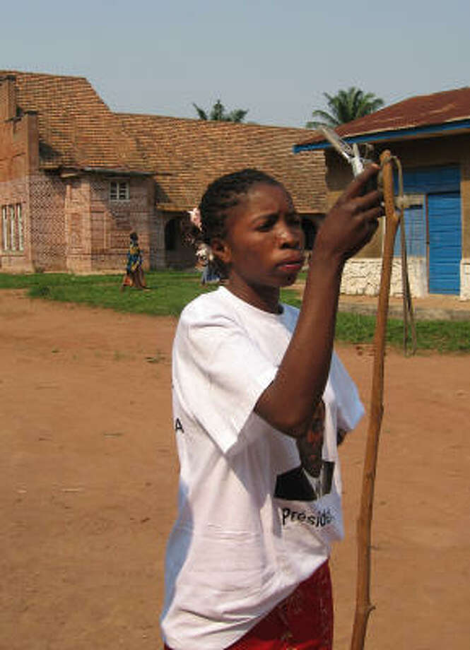 Congo S Industrious Poor Striving For Middle C!   lass Houston Chronicle - michline kapinga makes a call on a cellular phone attached to a bamboo pole in the