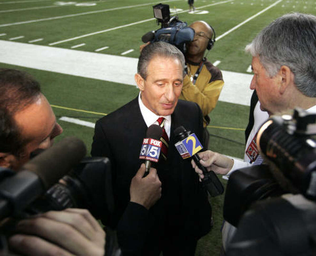 Atlanta Falcons owner Arthur Blank speaks to reporters before the Falcons-Saints game. Falcons quarterback Michael Vick was ordered to serve a 23 months prison sentence for running a dogfighting operation.