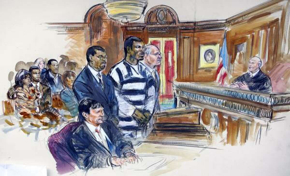 This artists rendering shows Michael Vick wearing a black-and-white prison suit flanked by his attorney's Billy Martin, left, and Lawrence Woodward as he is sentenced by federal judge Henry Hundson, far right, in Federal Court in Richmond, Va.
