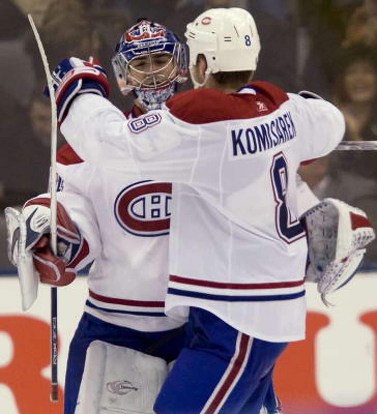Montreal Canadiens Michael Komisarek, right, congratulates goaltender Carey Price after winning the shootout against the Toronto Maple Leafs.
