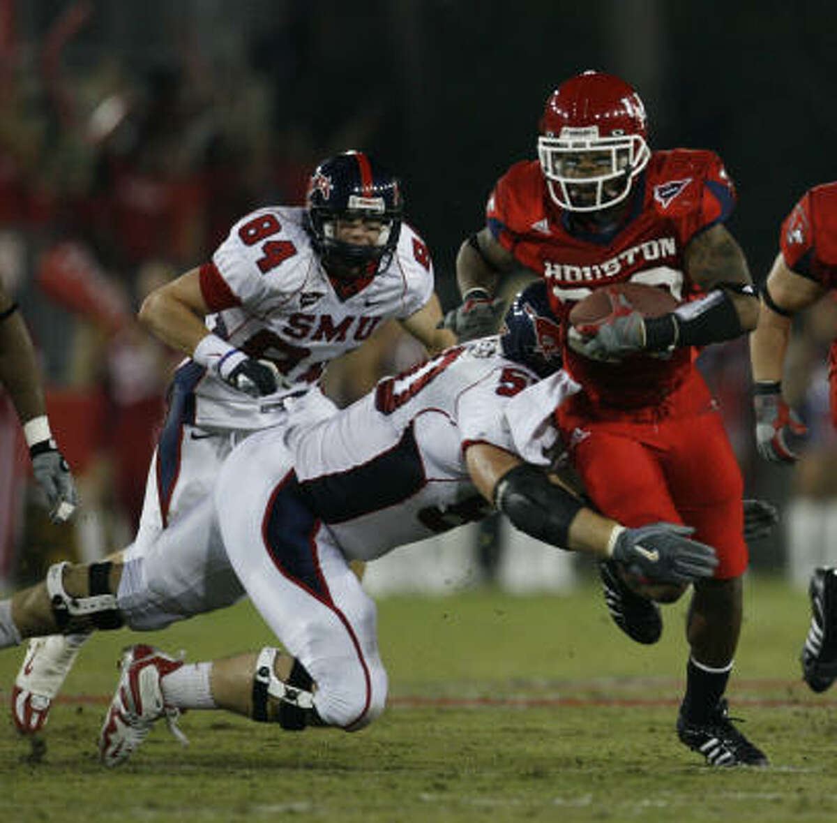 Houston's Kenneth Fontenette returns an interception during the Cougars' 38-28 win over SMU.