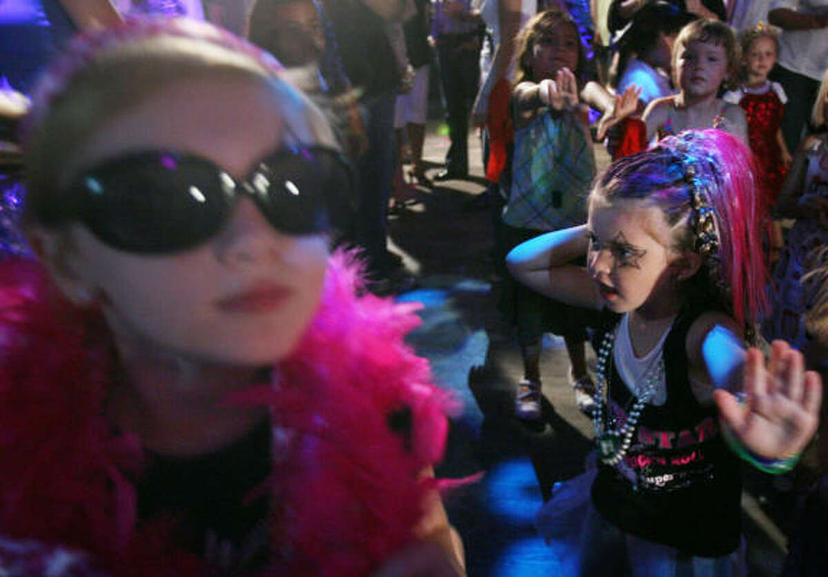 Reagan Main, 5, right, participates in the dance competition for ages 3 to 7 years old on the dance floor during the first "Baby Loves Disco" party where toddlers and children up to age 7 danced to disco music at Rich's Night Club