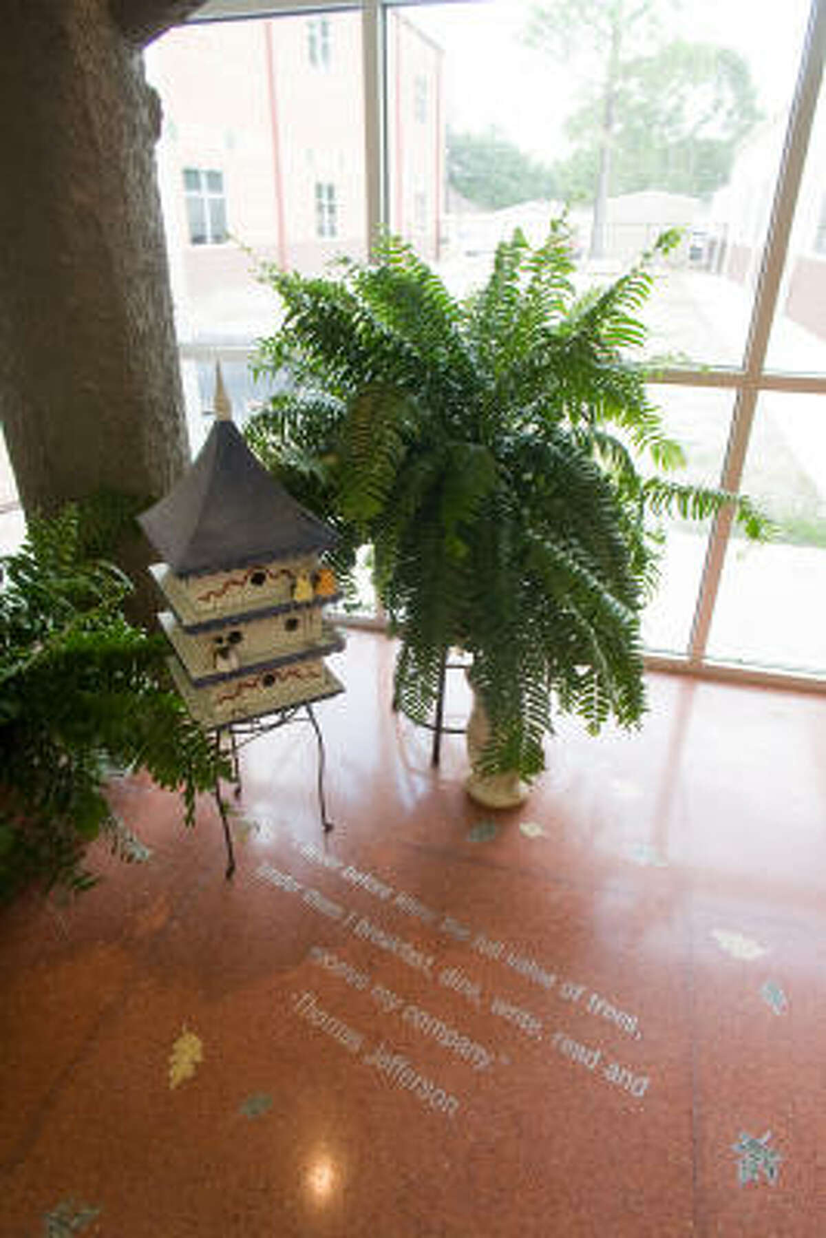The nature/sylvan motif carries throughout the new Walnut Bend Elementary School building. This artificial treetrunk, with birdhouse and plants, frames a quotation about trees from Thomas Jefferson.