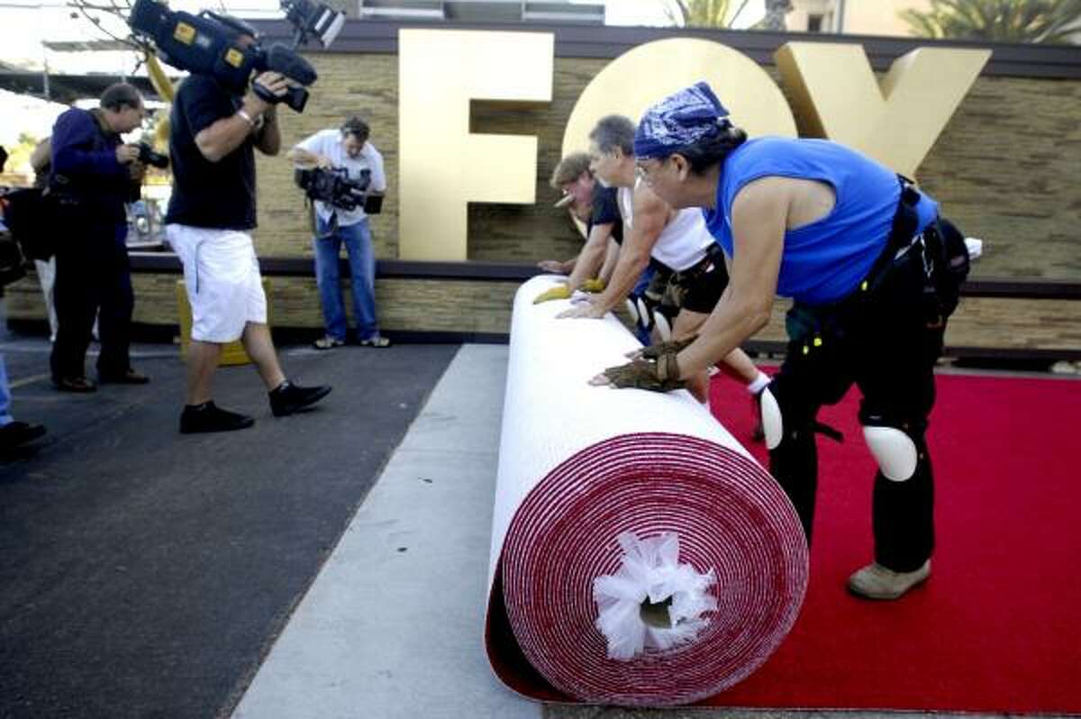 Workmen roll out the red carpet at the Shrine Auditorium on Sept. 13, 2007 in Los Angeles.