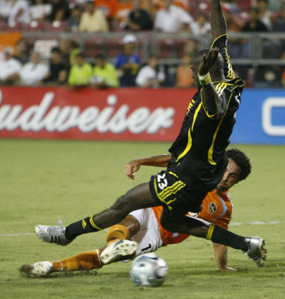 Dwayne De Rosario attempts to slide tackle the ball away from the Columbus Crew's Ezra Hendrickson.