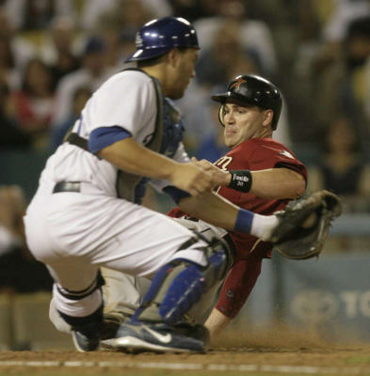 Right fielder Luke Scott slides under the tag at home by Dodgers catcher Russell Martin in the sixth inning.