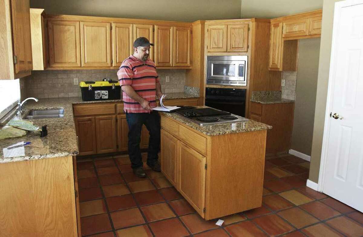 Home inspector Jeff Adams stands in the kitchen of a house for sale on Butlers Bridge Road. He says an inspection can take anywhere from two to five hours.