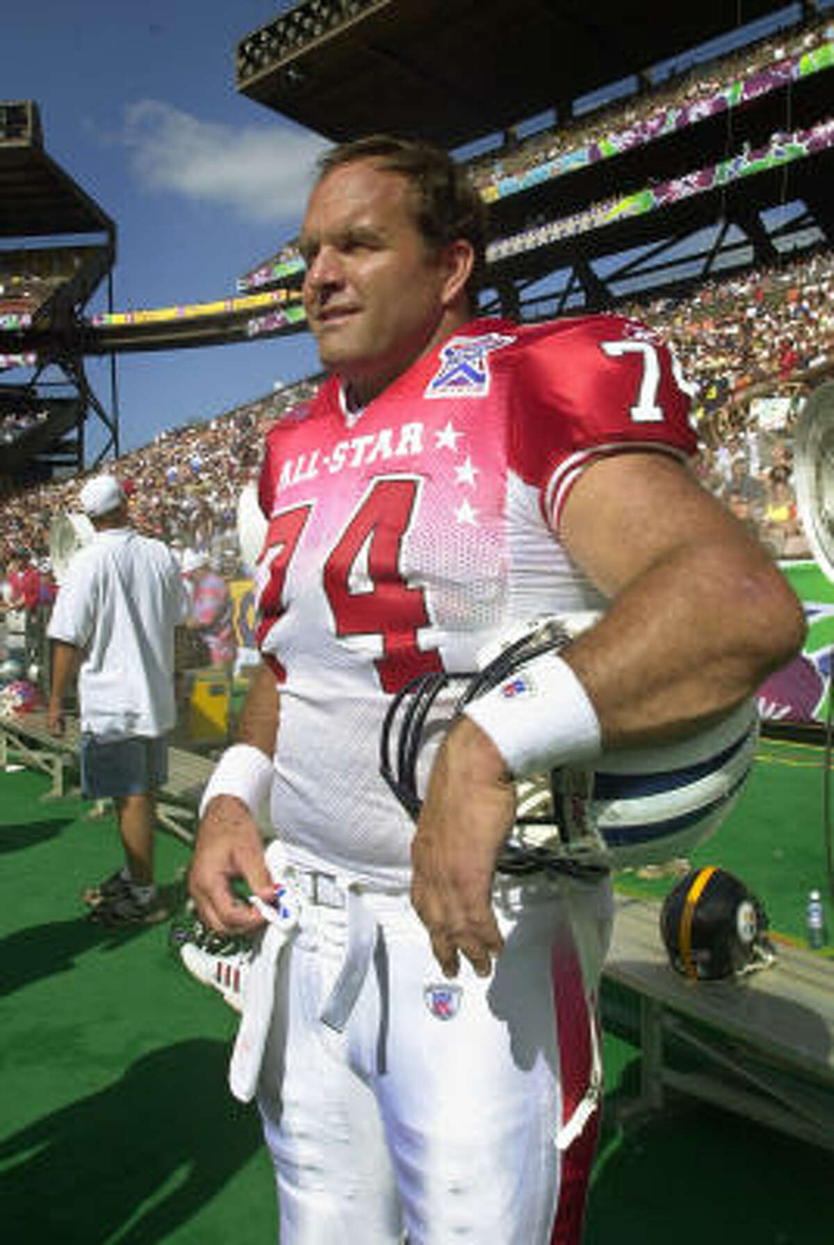 Veteran Tennessee Titan center Bruce Matthews surveys the action in the closing minutes of the Pro Bowl game on Feb. 9, 2002, in Honolulu. At 40, he was the oldest player on either squad playing in the game at Aloha Stadium. He also has the most Pro Bowl experience; Matthews' 14 consecutive selections tied him with Hall of Famer Merlin Olsen for the most ever.
