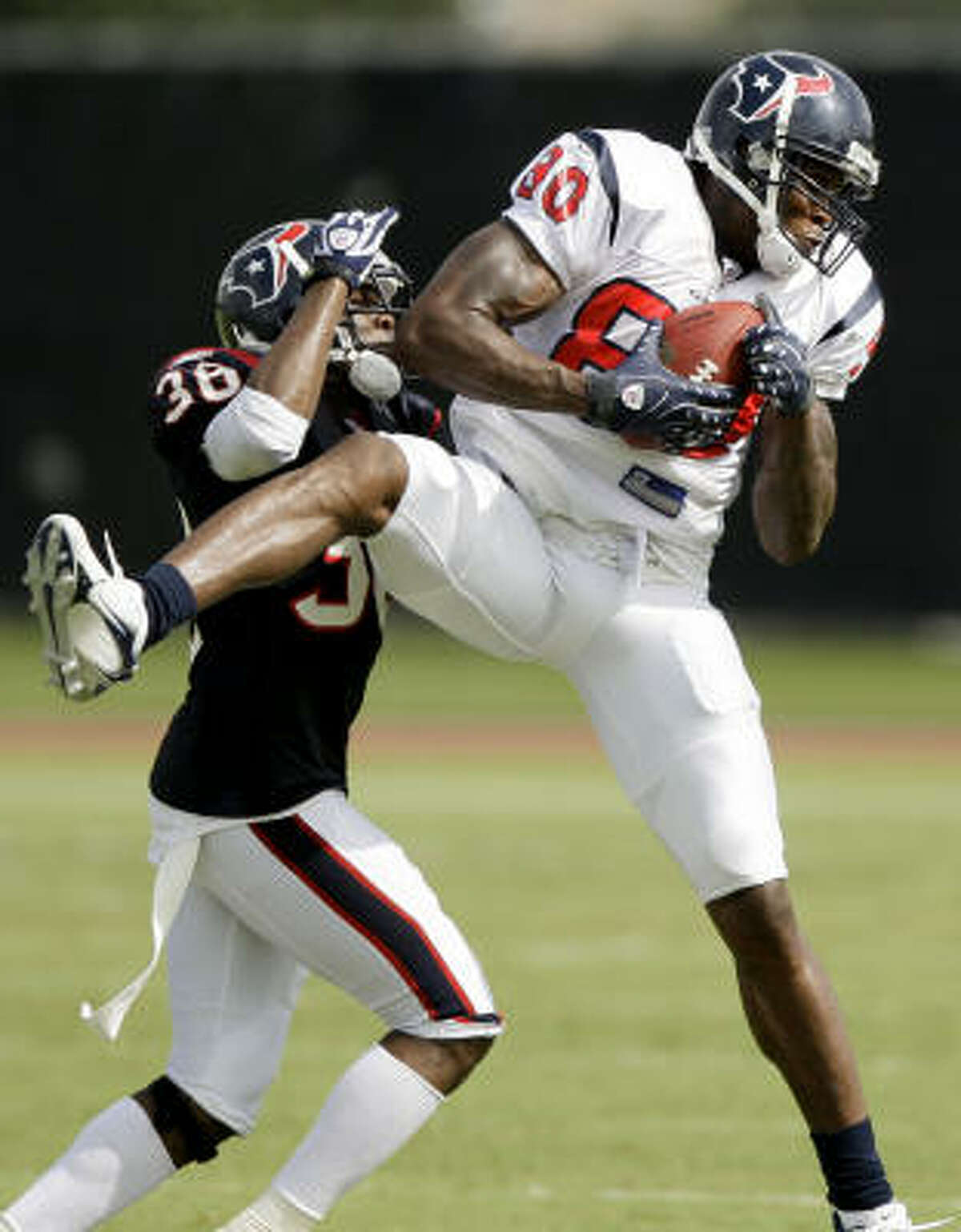 Texans wide receiver Andre Johnson goes up to catch a pass against cornerback DeMarcus Faggins.