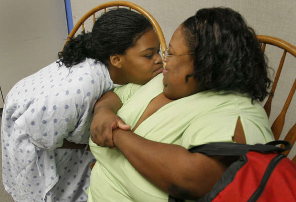 KeAira Willis, left, shares a moment with her mom, Trina Gulley just before plastic surgery Tuesday.