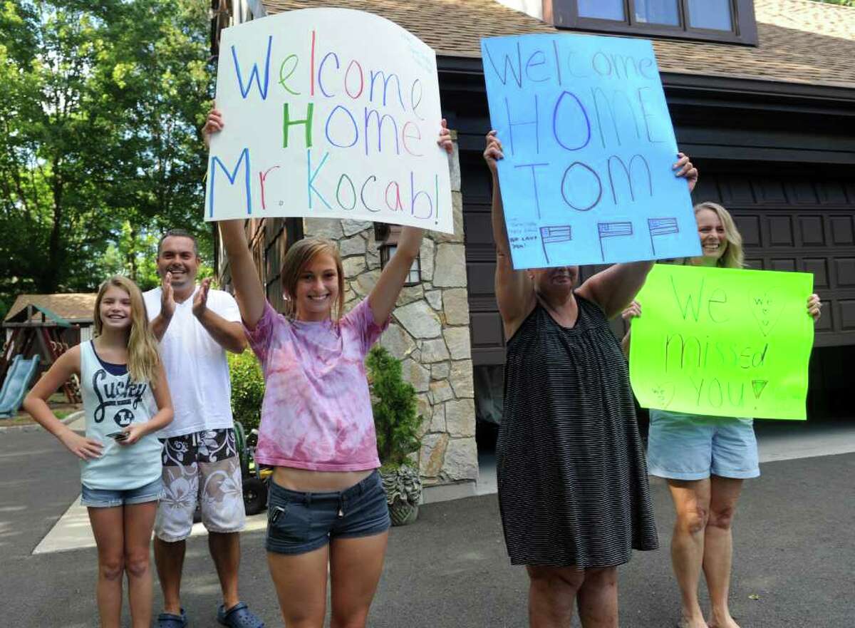 Friends and neighbors, from left, Taylor Rodrigues, 13, Mike Rodrigues, Dana Runko, 14, B.J. Berchem and Tracy Runko welcome home Tomasz Kocab Friday, August 12, 2011 after his release from U.S. Immigration and Customs Enforcement detention in Massachusetts. Kocab was granted a six-month reprieve from deportation to Poland.