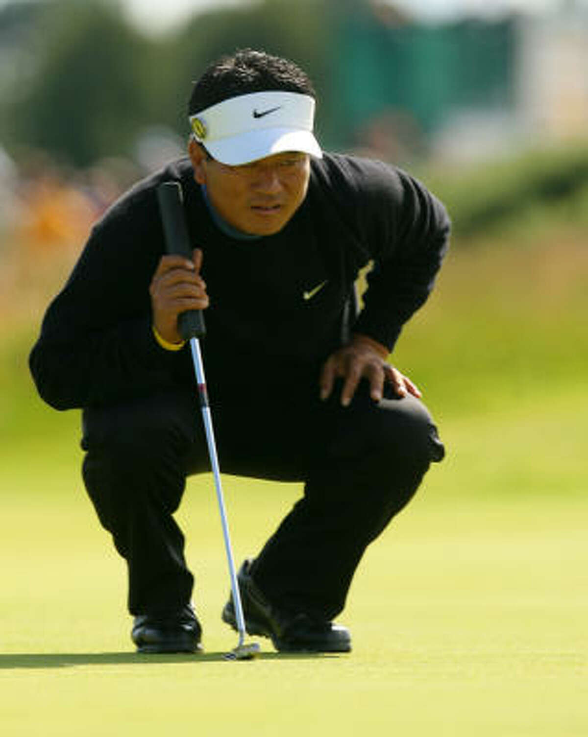 K.J. Choi reads the line on his putt on the 13th green during the second round.