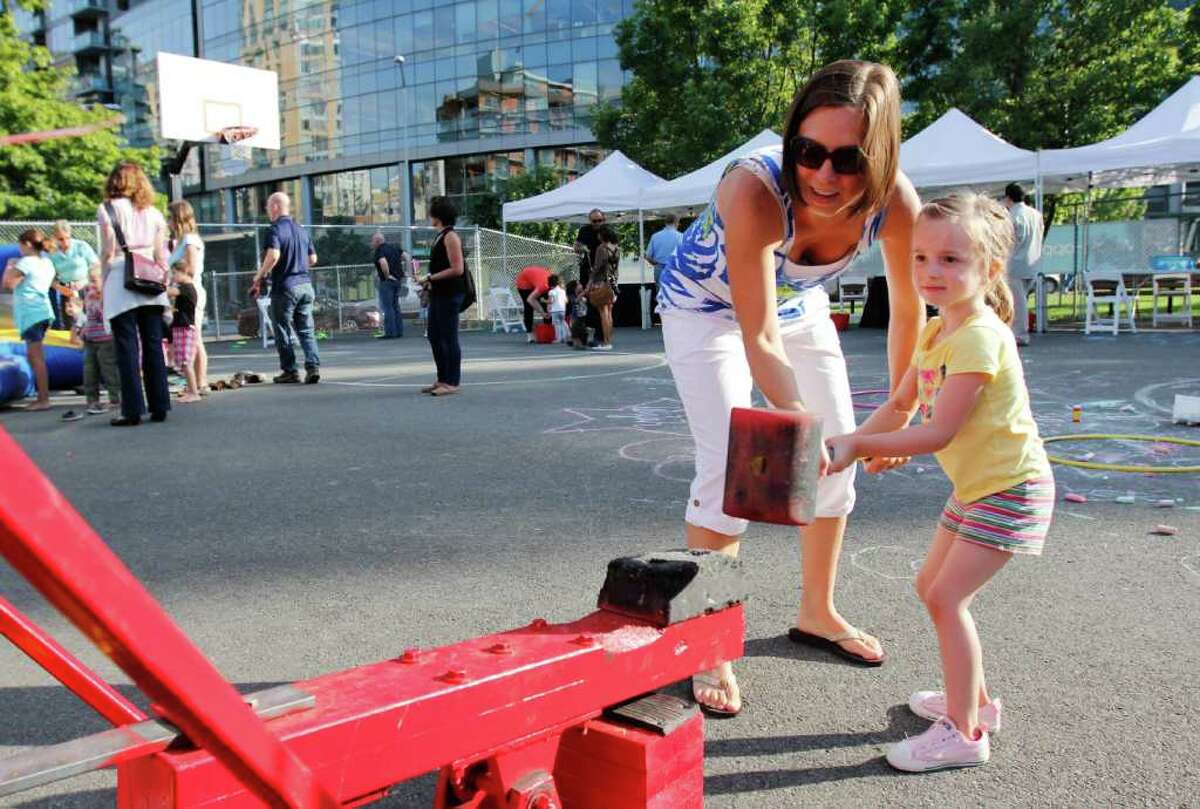 Dawn Dunn and her daughter Emily, 3, try to ring the bell.