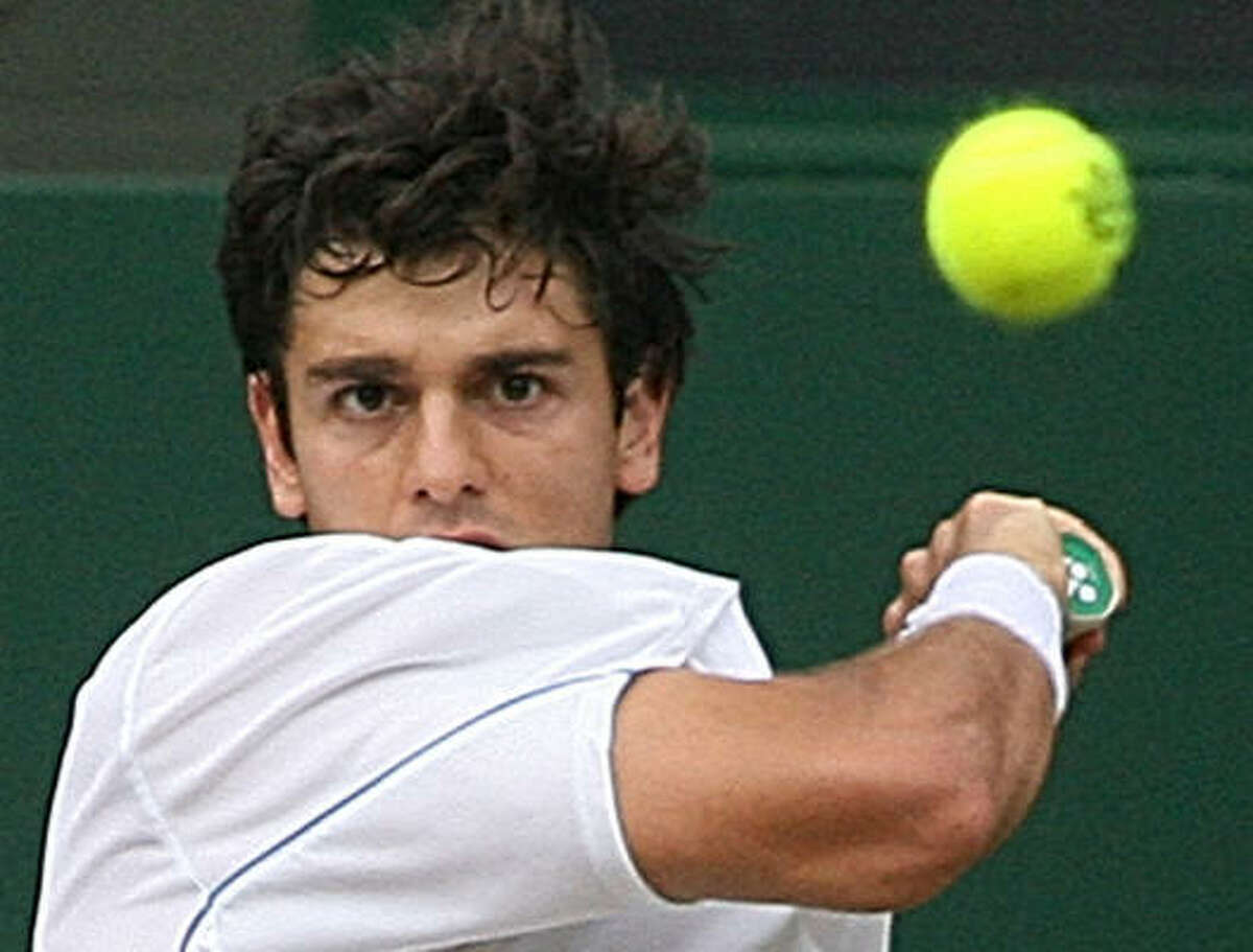 Mario Ancic hits a return to Roger Federer. Before Wednesday's loss, Ancic is the last person to have defeated Federer on grass.