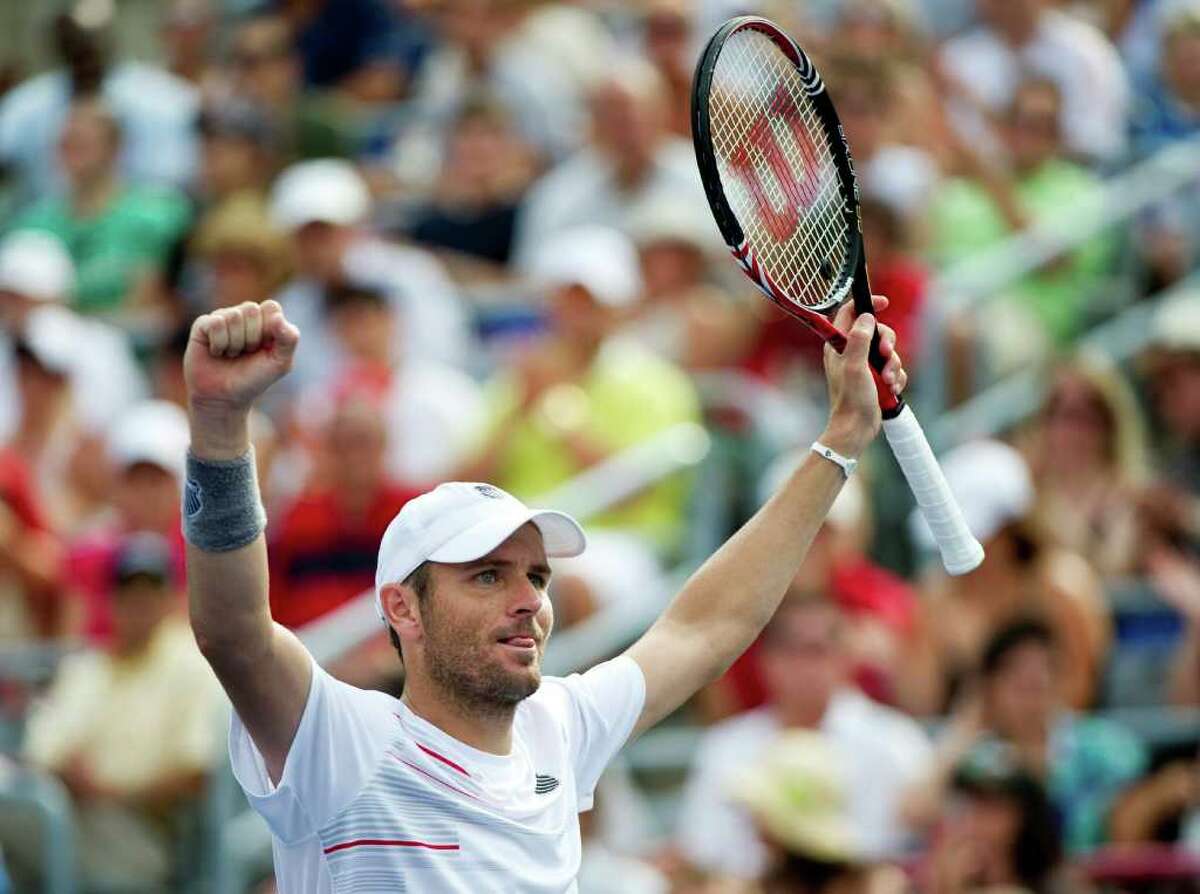 Mardy Fish, from the Unites States, celebrates his victory over Janko Tipsarevic, from Serbia, during semifinal play at the Rogers Cup tennis tournament on Saturday, Aug. 13, 2011, in Montreal. Fish won 6-3, 6-4 to move on to the final. (AP Photo/The Canadian Press, Paul Chiasson)