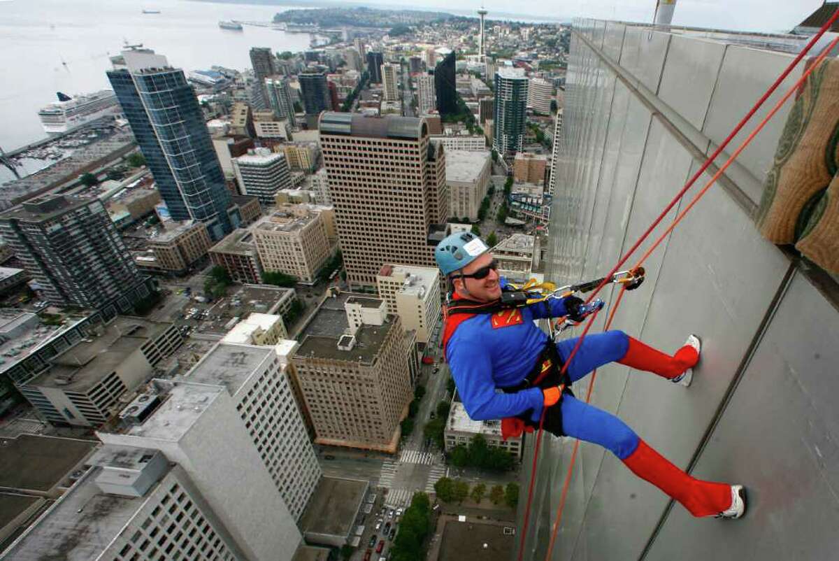 Craig Norris, dressed as Superman, begins his descent of Seattle's 41-story Rainier Square Tower during Over the Edge, a fundraiser for Special Olympics Washington, on Saturday, August 13, 2011 in Seattle. Nearly 200 people who raised money for Special Olympics Washington rappeled down the 514-foot tall building, which was built in 1977 and designed by Seattle native Minoru Yamasaki, who also designed the World Trade Center towers in New York.