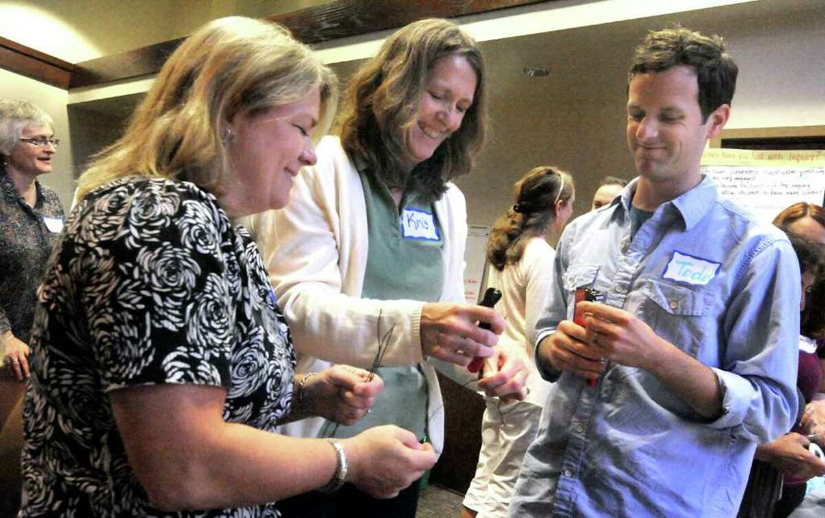 Susan Brofford, left, Kris Fed, and Todd Stentiford, cut wire for an electricity investigation during a Connecticut Science Center program for area teachers held at Western Connecticut State University in Danbury Monday, Aug. 15, 2011.