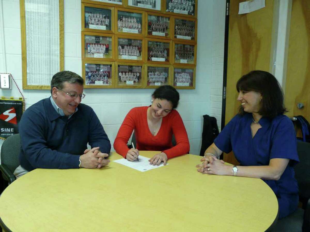Fairfield Ludlowe's Elise Perazzini, middle, signs a National Letter of Intent to compete on the track team at Bucknell University. Perazzini, is joined by her dad, at right, Frank and mom, Pat.