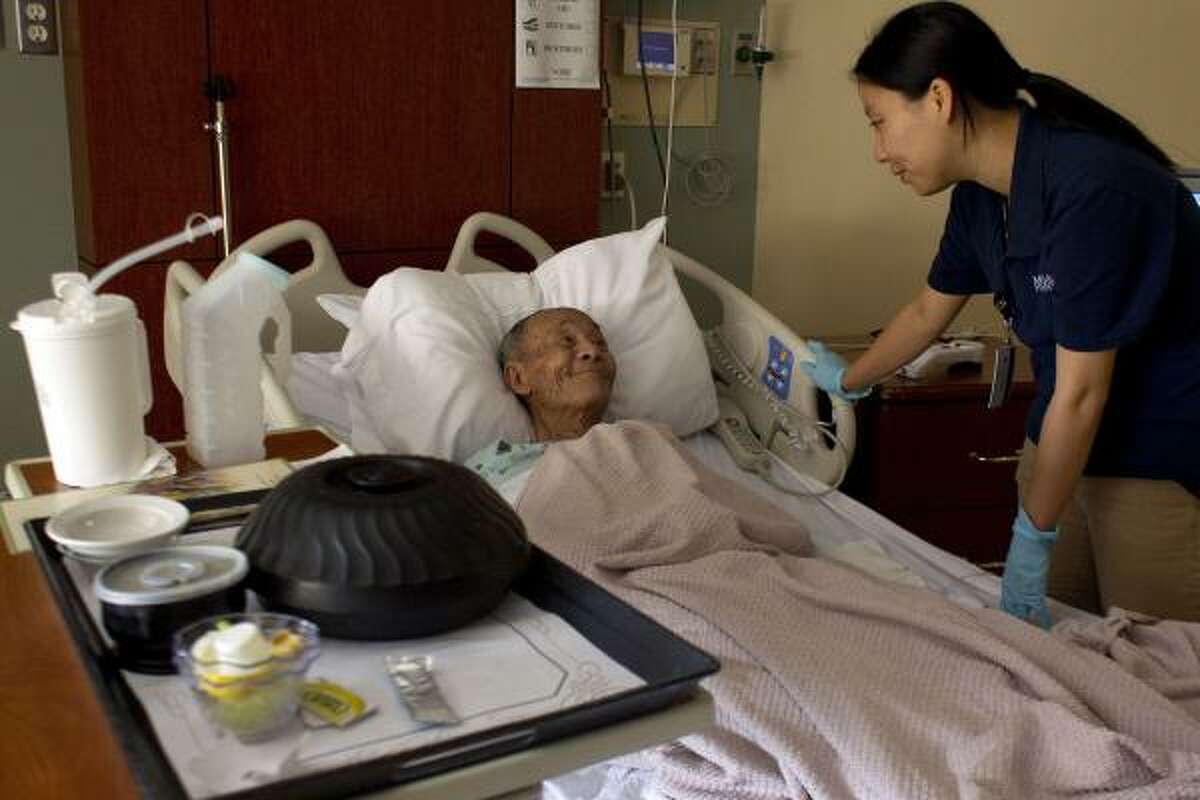 Patient Chuong Tran, 84, originally from Vietnam, talks with Vietnamese interpreter Vivi Nguyen at Memorial Hermann Southwest. The hospital serves a growing Asian community.
