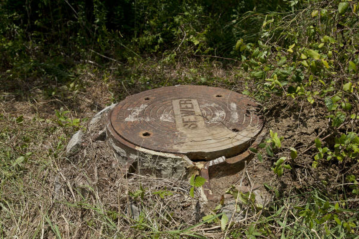 A 25-year-old League City man identified as Kevin Gonterman was rescued Monday, 30 feet down in this manhole. The cover was nearby when he was found.