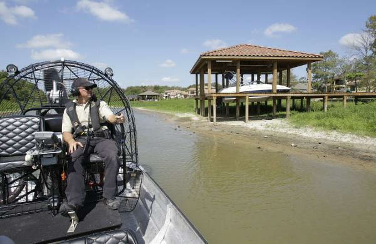 Texas game warden Kevin Creed's patrol of Lake Houston on Wednesday revealed boats in landlocked boathouses.
