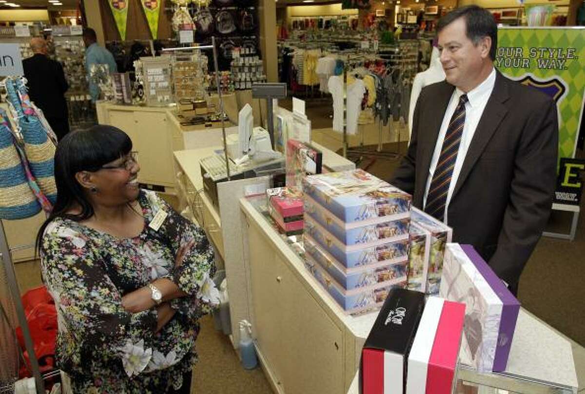 Valerie Garrett, left, a Palais Royal cosmetics sales associate, visits with Stage Stores CEO Andy Hall at the Northline Mall. Stage is the parent of Palais Royal, which has 40 locations in the Houston area. But Stage, which also has Bealls, Goody's and Peebles, operates most of its stores in smaller towns.