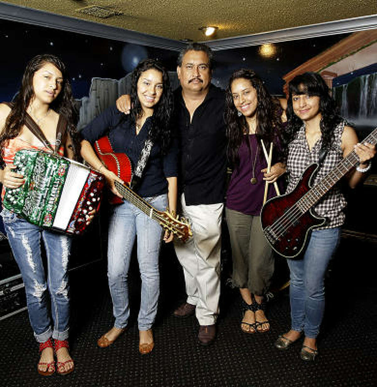 David Rodriguez, shown with the daughters who make up the group Las Fenix, knows he made a good choice all those years ago when he decided to seek his fortune in Houston.