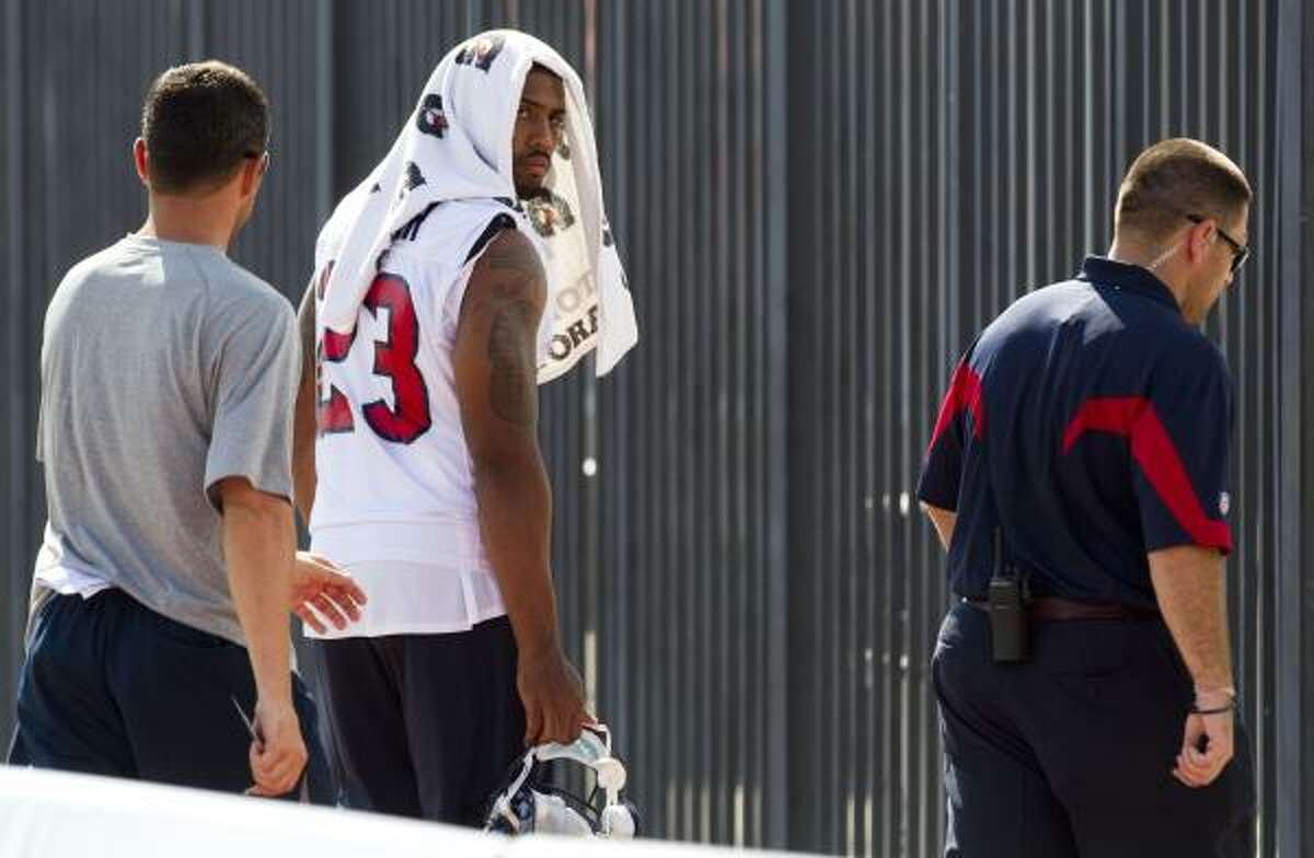 Texans running back Arian Foster walks off the practice field after his hamstring tightened up.