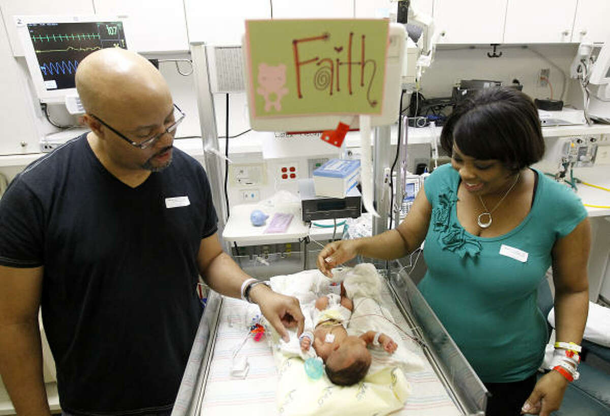 Ivan and Colette Hagler and their daughter, Faith, at Children's Memorial Hermann Hospital on July 8, four days after her birth. Faith's fetal surgery will allow her to walk, doctors say.