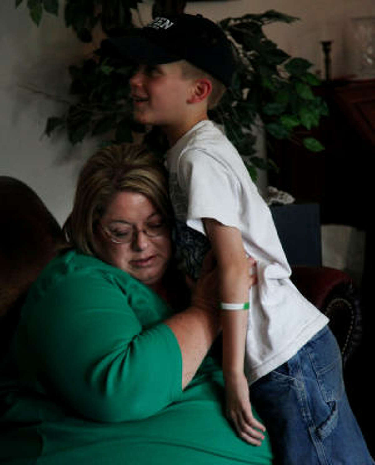 Dana Janczak listens to her 10-year-old son Nathanael's chest after his pulmicort treatment in their rural Cleveland home. Janczak said she and her children suffer from asthma and find access to a doctor difficult.