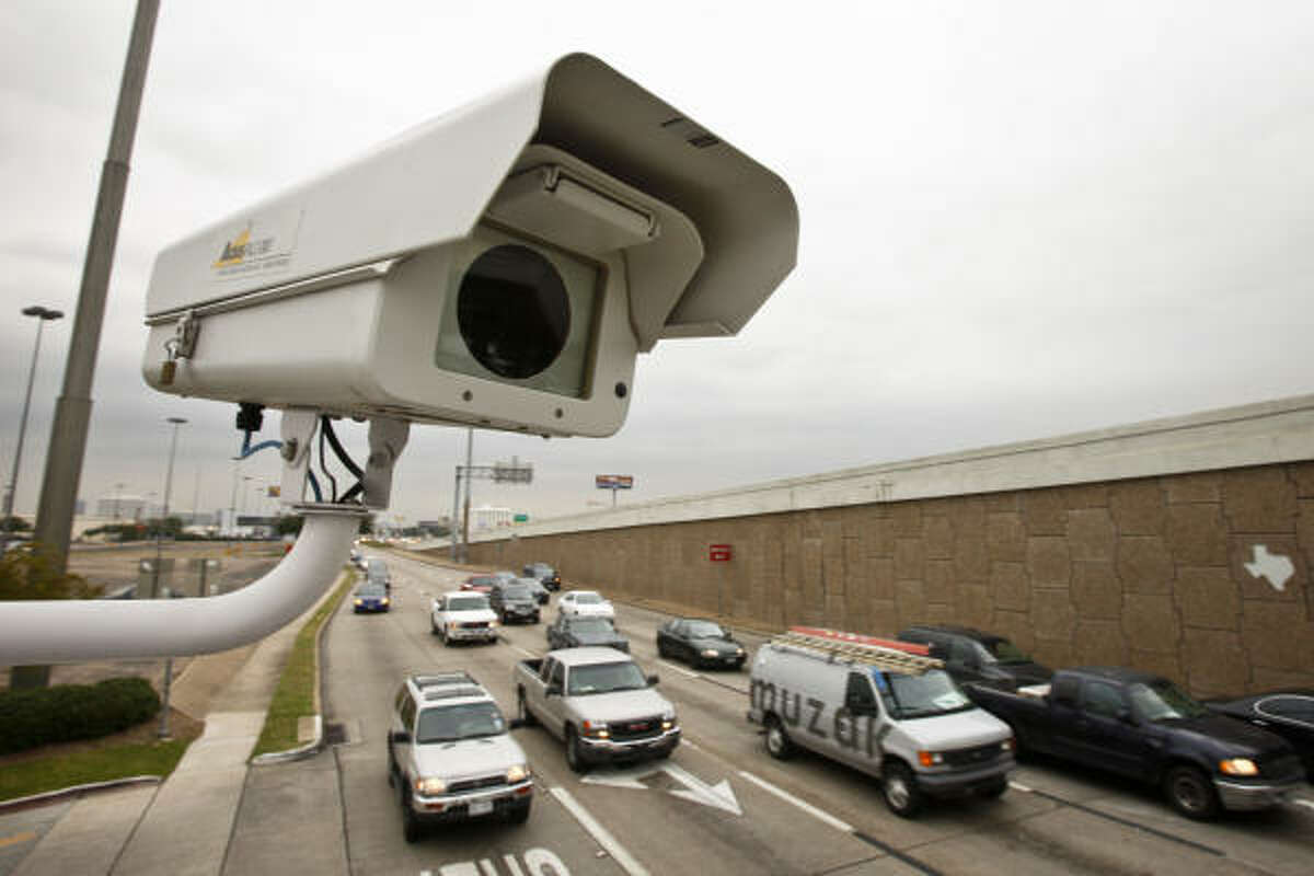 A red light camera perches above traffic at the intersection of Southwest Freeway and Bellaire Blvd. Monday, Nov. 15, 2010.