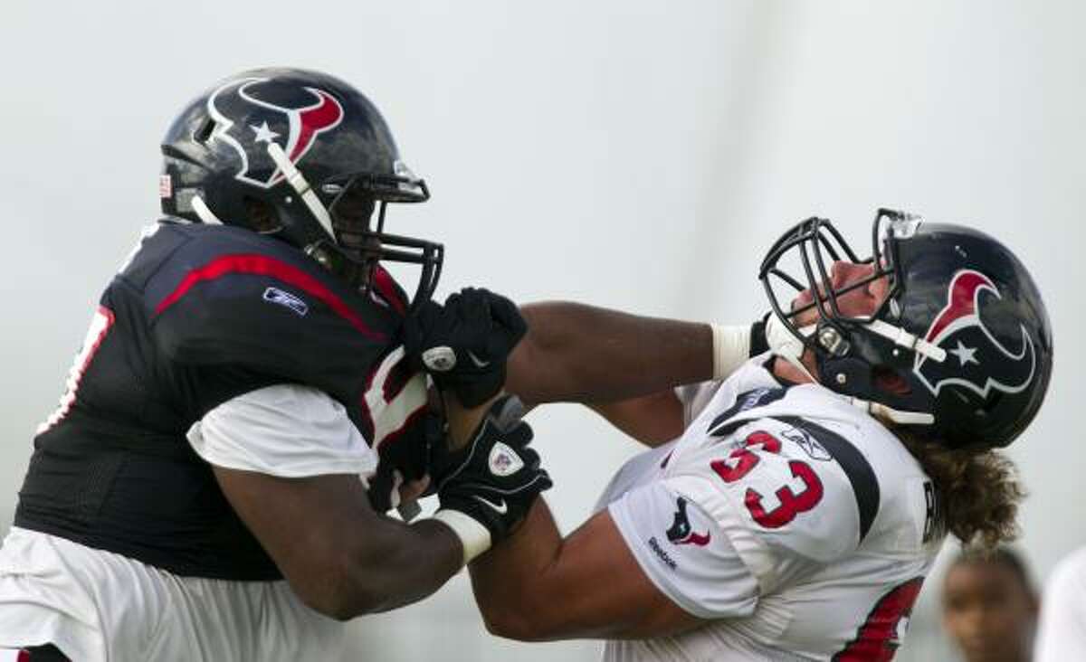 Defensive tackle Damione Lewis, left, an 11-year veteran, mixes it up with rookie guard Howard Barbieri on Tuesday.