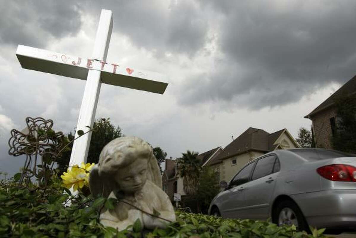 A cross stands at the intersection of Hidalgo and McCullough Circle in memory of Jett Ogansoy, a 6-year-old killed by a car while walking to school with his mother in October 2008.