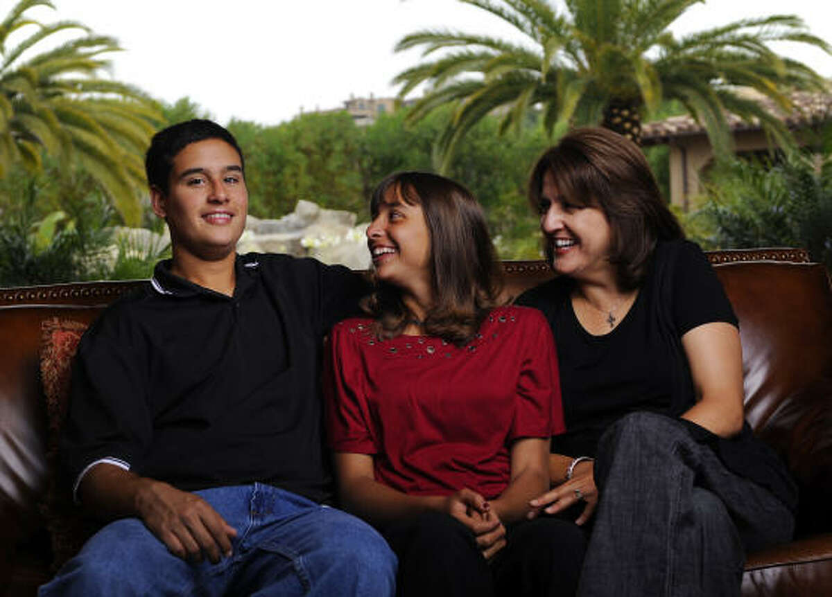 Retta Beery, right, and her twins, Noah and Alexis, 14, at their Encinitas, CA, home on Tuesday. The twins were misdiagnosed with cerebral palsy when they were young and Alexis nearly died twice due to breathing problems. The twins got their whole genomes sequenced at Baylor College of Medicine, and were able to precisely diagnose the problem.