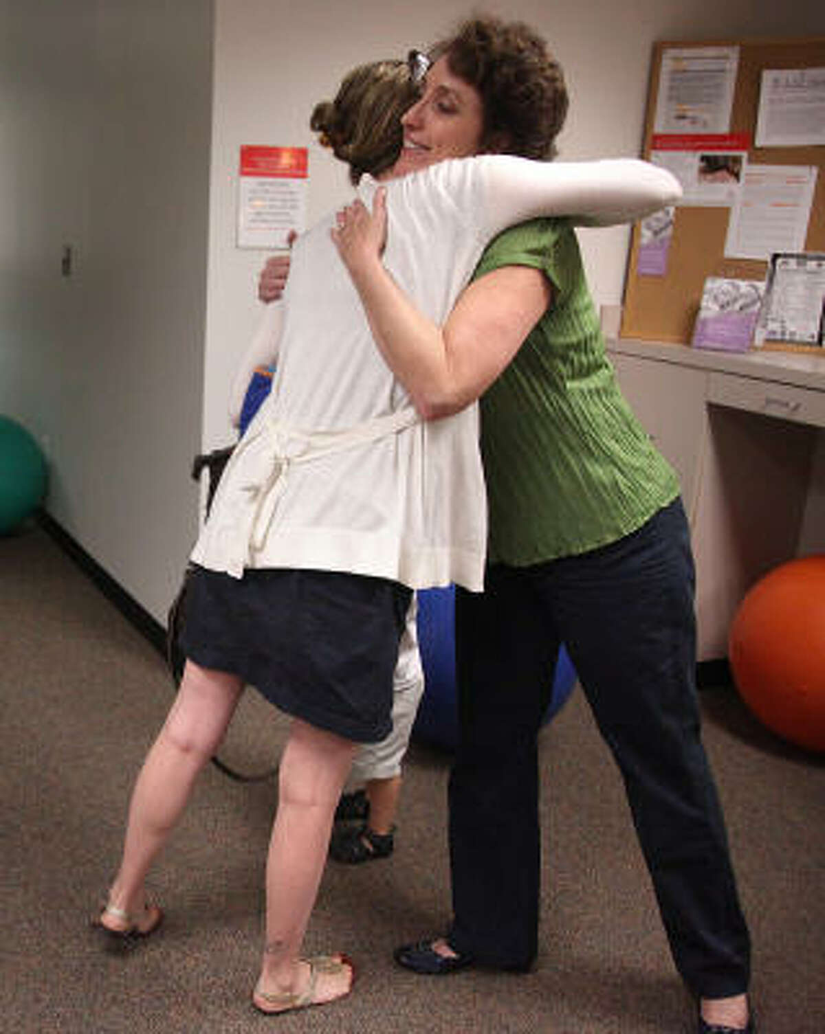 Juliana Heyward thanks therapist Sherry Duson after a meeting of a free postpartum depression support group at Texas Children's Hospital.