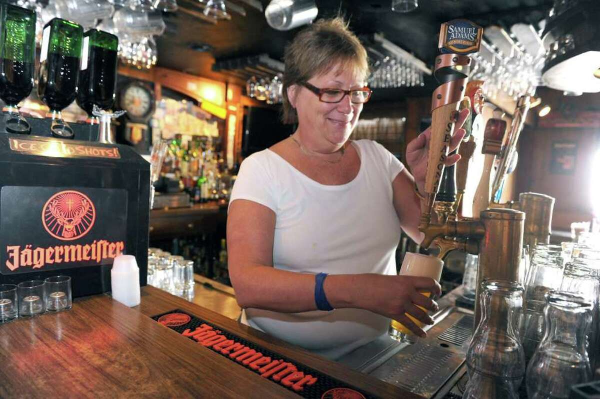 Nancy Silverman, owner of the Georgetown Saloon, pours a drink in the bar. Photo taken Friday, August 19, 2011.