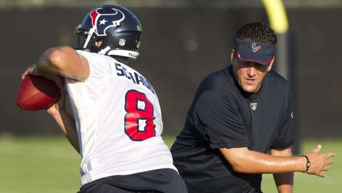Texans quarterback Matt Schaub dodges past quarterbacks coach Greg Knapp in 2011.