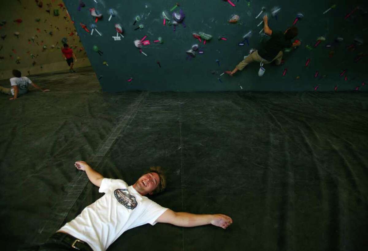 Mike White rests on the padded floor after a climb at the Seattle Bouldering Project. The Seattle Bouldering Project is a unique indoor climbing gym. Ropes are not used at the gym and climbers that fall land on 16 inch deep pads on the floor.