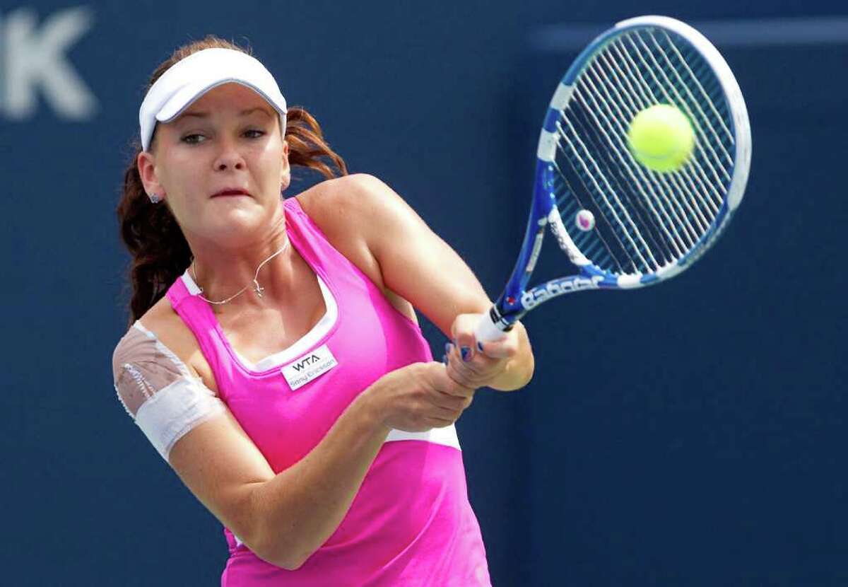 Agnieszka Radwanska, of Poland, hits a return during her semifinal match against Samantha Stosur, of Australia, at the Rogers Cup women's tennis tournament in Toronto Saturday, Aug. 13, 2011. Stosur defeated Radwanska 6-2, 5-7, 6-2. (AP Photo/The Canadian Press, Darren Calabrese)