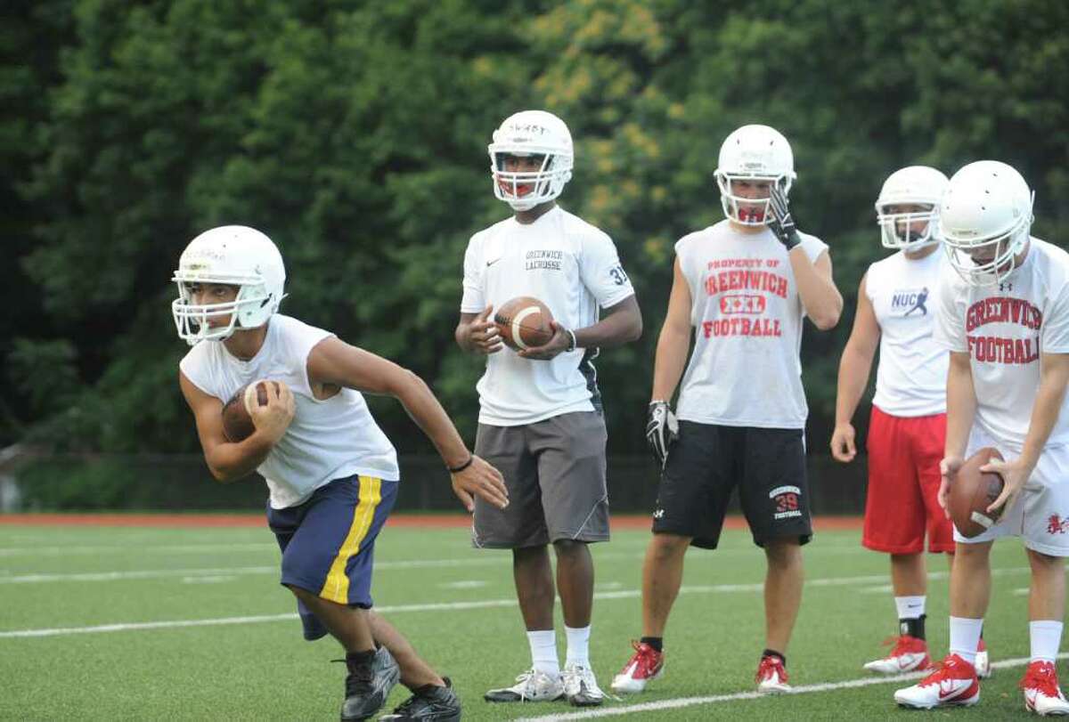 Zak Blechman, left, at Greenwich High School football team's first practice of the season on Monday, Aug. 22, 2011