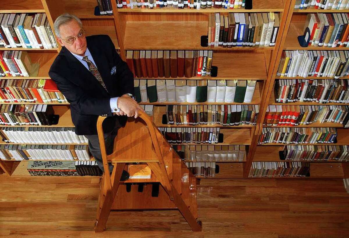Harry W. Mazal, posed on a stepladder amid the Mazal Holocaust History Library's books and documents, battled cancer for 15 years. His life's work of discrediting Holocaust deniers "was his passion," his daughter says. "It was his heart."
