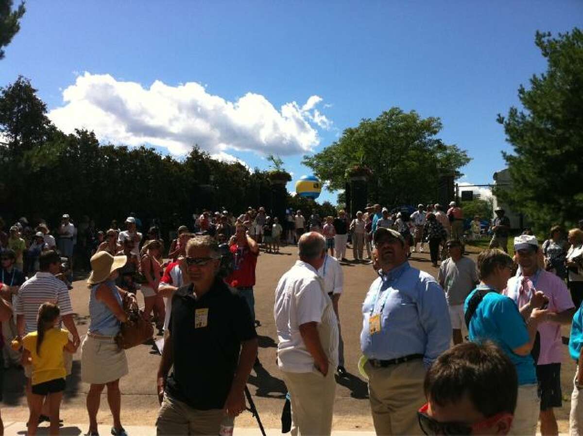 Spectators gather outside the Connecticut Tennis Center after being evacuated due to tremors felt from the earthquake that originated in Virginia Tuesday, August 23, 2011.