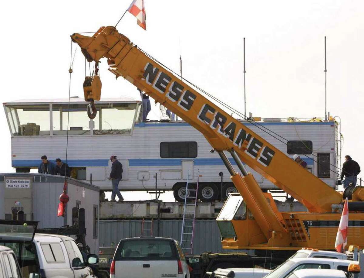 A construction crane swings away from a mobile control tower at Sea-Tac Airport on March 3, 2001. The crane put the trailer on top of a shipping container to provide a better view of the runway. The main tower at the airport was damaged in the Nisqually earthquake on Feb. 28, 2001.