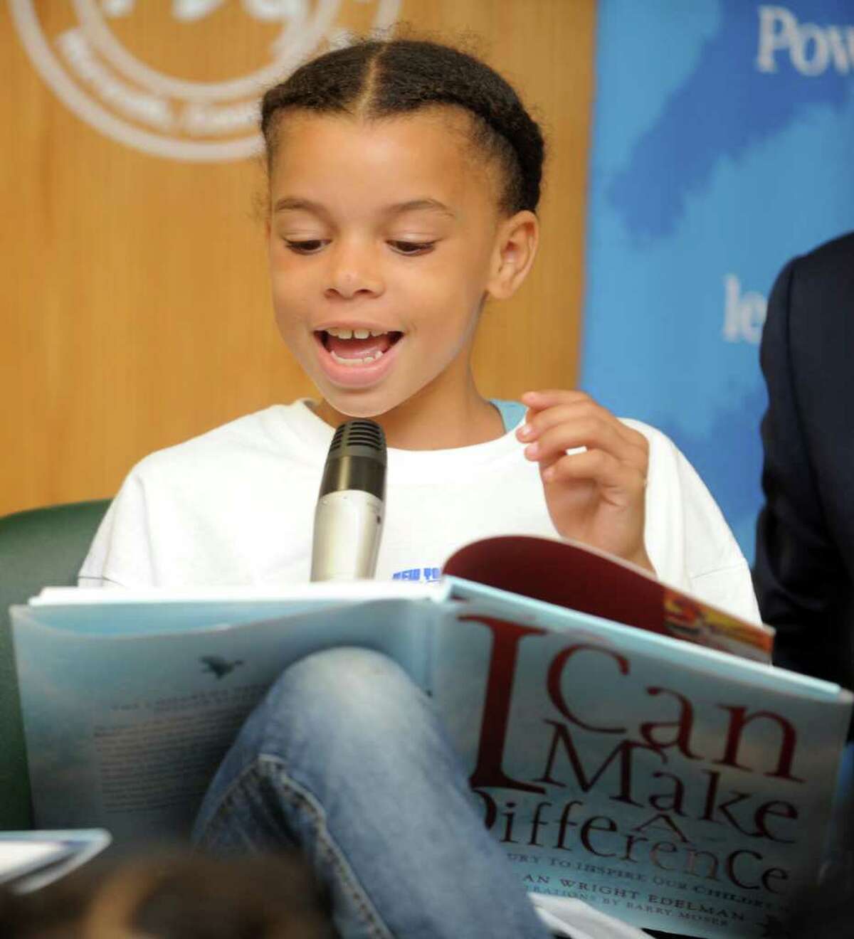 Nine-year-old Hyana Toigo, of Norwalk, reads an excerpt from the childrenís book "I Can Make a Difference," by Marion Wright-Edelman, Tuesday, Aug. 23, 2011 during Cablevisionís 2011 Knicks Read to Achieve program at South Norwalk Library.