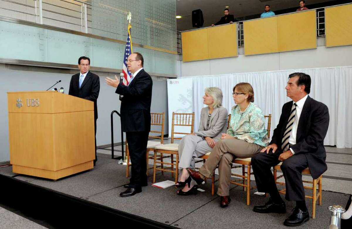 Connecticut Governor Dannel P. Malloy, left, speaks with UBS Americas Chief Executive of Phil Lofts in a press conference in the UBS building in Stamford on Tuesday, August 23, 2011.