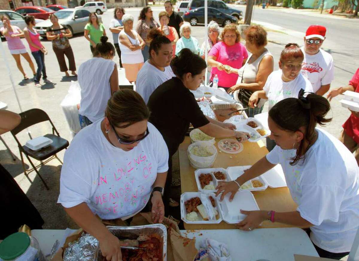 Family members of Port Aranasas crash victims Jacob Isaac Ricarte, 8, and Jelena Joli Robles, 3, make barbecue plates Tuesday, Aug. 23, 2011 at the Bud Jones Restaurant parking lot at 1440 SW Military Dr. as people line up to be served. "I can't believe so many people came out" Jade Castanon, sister of Jeanette Castanon, the mother of one of the victims, said after the family served 11 briskets in 1 1/2 hours.