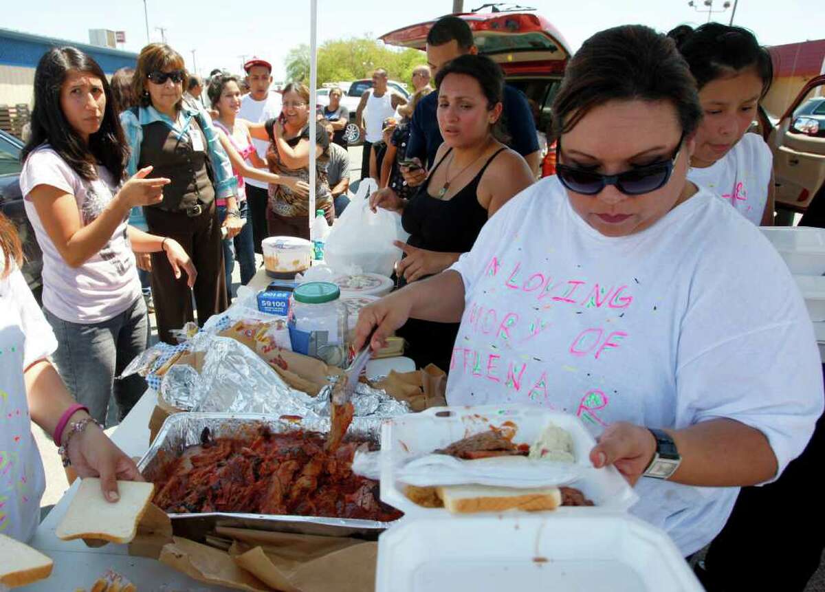 Family members, including Deborah Parez, right, of Port Aranasas crash victims Jacob Isaac Ricarte, 8, and Jelena Joli Robles, 3, hold a benefit barbecue plate sale Tuesday, Aug. 23, 2011 at the Bud Jones Restaurant parking lot at 1440 SW Military Dr.