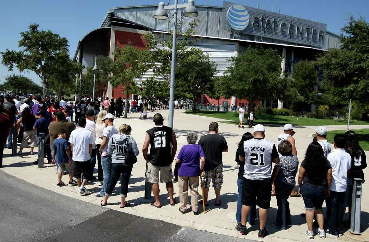 Spurs fans wait in line in October 2010 to enter the AT&T Center for a Spurs practice. With an eye fixed on an NBA lockout, Bexar County has asked the Spurs to re-evaluate when the organization expects to begin spending $75 million in bond money earmarked for capital improvements at the county-owned AT&T Center.