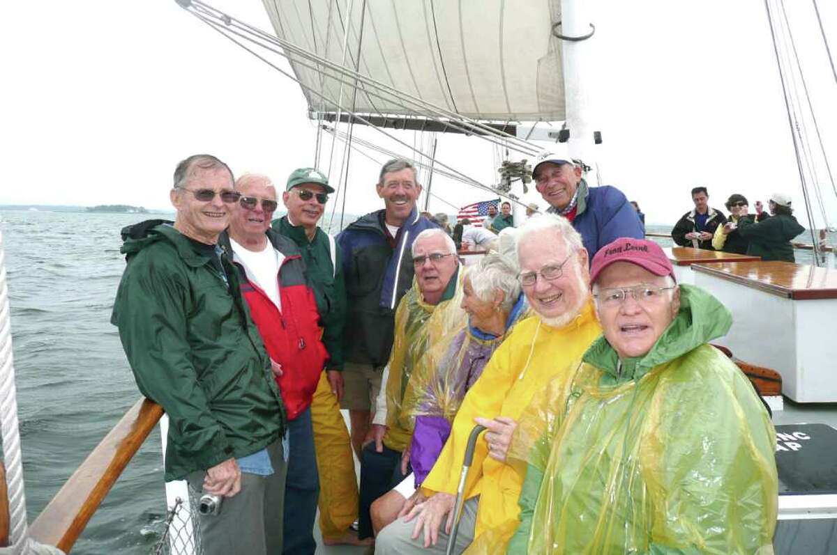 Eight of the 18 circumnavigators who sailed on Yankee back in 1953, plus a son of a late crew member, took part in a blustery reunion sail along the Greenwich coastline aboard the SoundWaters schooner. They are, standing from left, Roger Bellinger, John Herrick, Robert Johnson, Sean Bercaw, son of Jay Bercaw and Dick Blair. Seated are Mike Wilcox, Lydia Edes Jewel, Ken Viard, and David Wilkins. One crew member, Edith Corning stayed ashore.