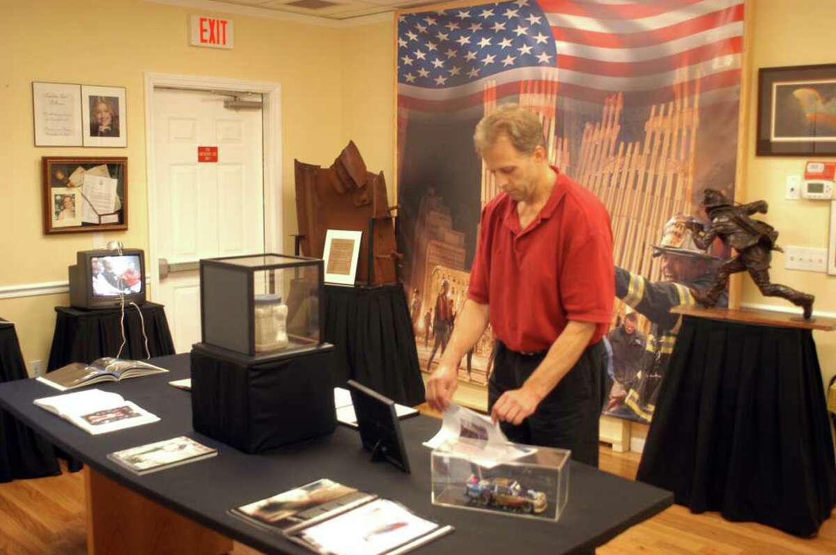 New Fairfield Assessor Richard Seman examines some of the exhibits in the townís 9/11 memorial which are available for public viewing in the Selectmanís Conference Room at Town Hall. Some overall shots of the display, which includes parts of the South Tower of the World Trade Center and memorials to local residents who lost their lives in the attack.